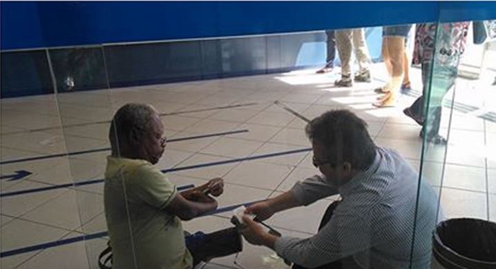 El gerente de un banco se sentó en el piso para atender a un cliente discapacitado y la imagen explotó en las redes sociales | Redes