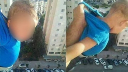 Con su hijo colgando desde un piso 15, pidió en Facebook "1000 me gusta o lo soltaré"
