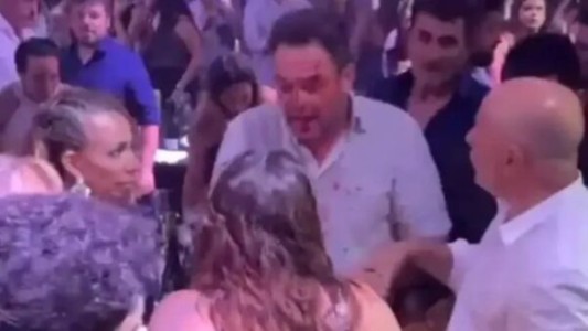 Padres a las piñas en una fiesta de graduación