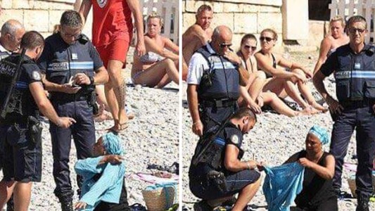 Polémica por la imagen de policías que rodean a una mujer para que se quite la burkini